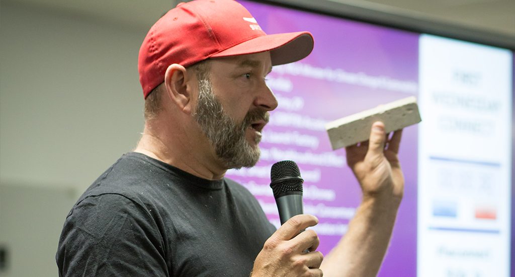 MCi CEO Marcus Dawe holding his carbon brick product