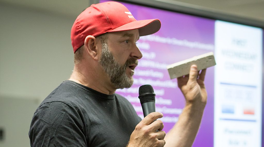 MCi CEO Marcus Dawe holding his carbon brick product