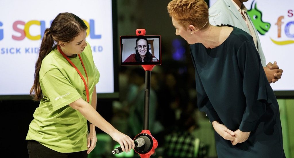 Meghan Gilmour, founder of MissingSchool demonstrating the robots.