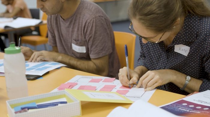 Researcher writes on canvas in workshop