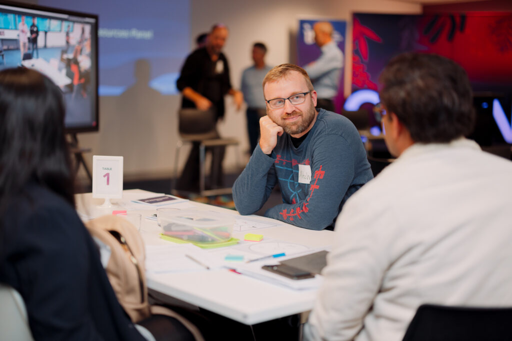 Man listening to people talking at table