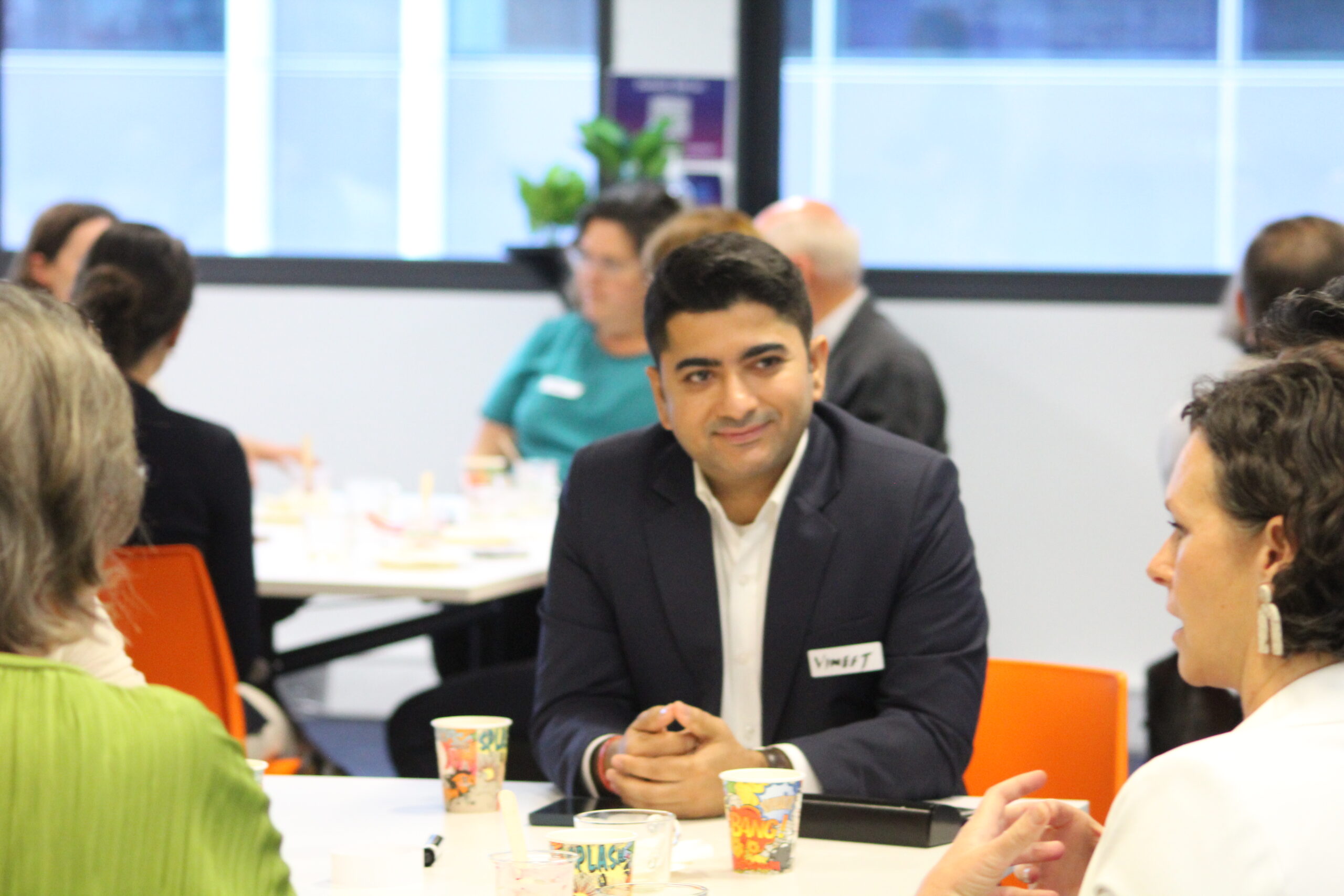 Person in suit listening at breakfast